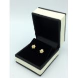Pair of rose gold diamond daisy style earrings