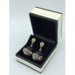 Pair of silver Cartier style onyx, Panther earrings with ruby eyes