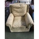 Armchair upholstered in yellow/gold fabric