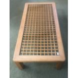 Contemporary coffee table with wooden lattice pattern beneath a glass top (v small chip in glass