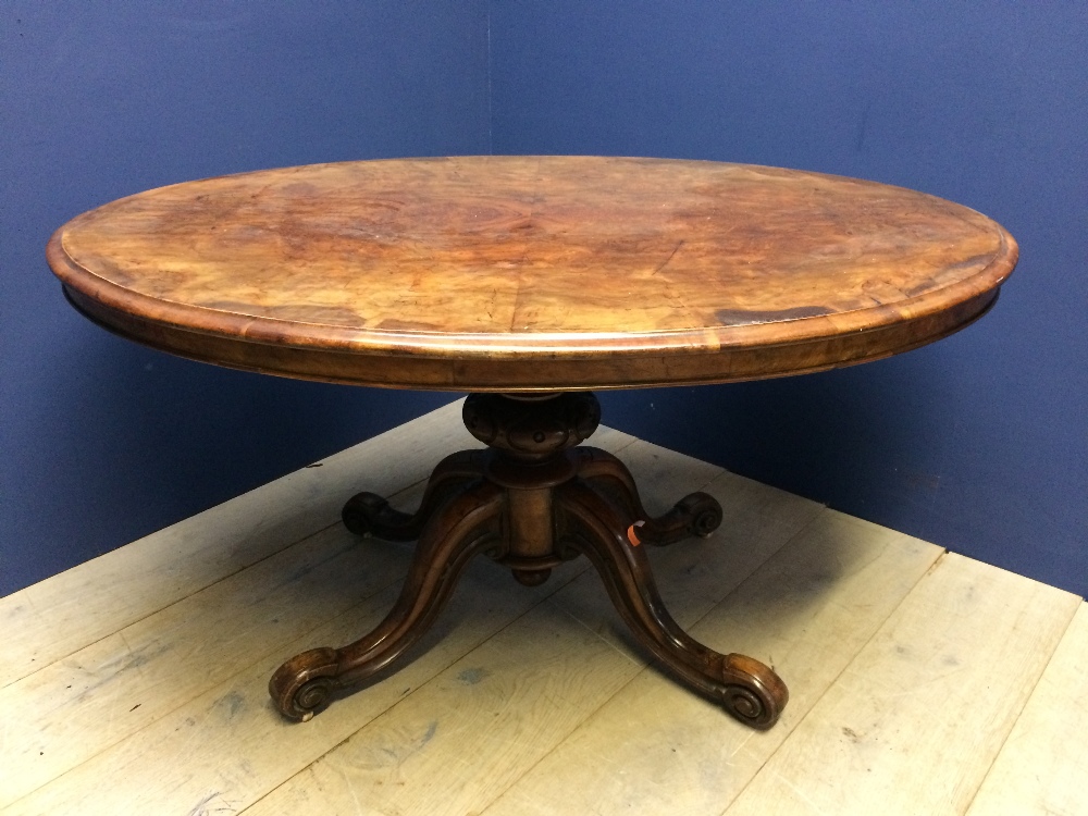 Victorian walnut veneer oval snap top breakfast table to quadruped base and china castors. 135 x 103