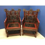 Pair of large Chinese red lacquered armchairs the back and sides with fretwork panels depicting
