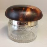 Early C20th glass, hallmarked silver tortoiseshell screw top dressing table jar, base 6cm dia