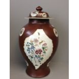 Oriental lidded baluster vase decorated in brown decorated with flowers on a white ground 43cm H
