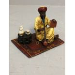 Cold painted bronze depicting man wearing Turban and robes, sitting on a rug with a pipe 6cm