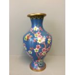 Oriental Cloisonne waisted vase with prunus & butterfly decoration to a blue ground (damaged)
