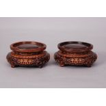 A pair of Chinese carved wood circular stands (2)