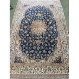 Light brown rug, with central blue & brown medallion 177 x 287 cm (has a hole)