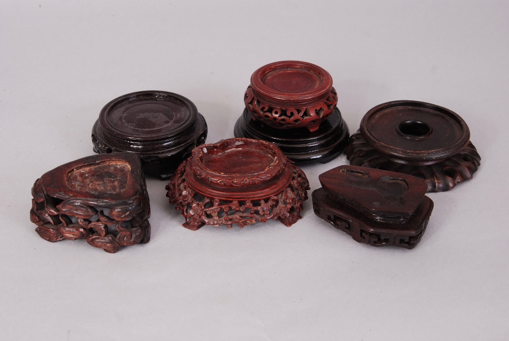 A group of seven Chinese wood stands. (7)