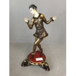 Painted metal & ivorine figure of a lady dancing & a base supported by Elephants