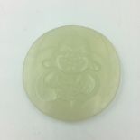 Chinese carved jade circular pendant depicting Buddha