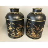 Pair of black tea storage canisters decorated in gilt, red & green with flowers & birds