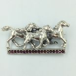 Silver brooch in the form of 3 horses on a ruby platform