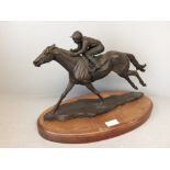 Bronze sculpture on wooden plinth of racehorse Dancing Brave, Signed, Davina May. One rein missing