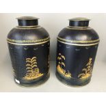 Pair of dark blue tea storage canisters decorated in gilt & greens depicting a man with a fishing