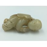 Chinese Jade carving of a boy carrying a lotus leaf 6cm