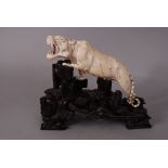 C18th/19h Chinese ivory carving of a tiger, fitted wood stand, 26.5cm long.