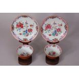 A pair of Chinese café-au-lait glazed famille rose cups and saucers decorated with peonies,