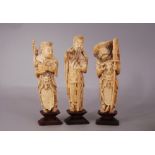 A set of three C18th/19th Chinese ivory figures, wood stands, overall 23cm high. (3)