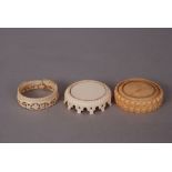 Three C19th Chinese carved ivory circular stands. (3)