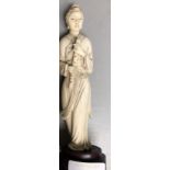 Carved ivory figure of a lady holding a musical instrument on modern wooden stand 15.8 cm