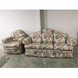 Two 3 seater sofas & a pair of arm chairs with loose covers in a floral pattern