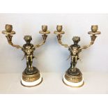 Pair of candelabras each with a cherub holding a double branch, bronze, ormolu & marble