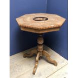 Octagonal pedestal table intricately inlaid with a selection of woods & centered with a circular