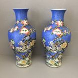 Modern pair of baluster vases decorated with flowers, & birds on a blue ground