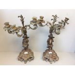 Pair of 3 branch metal candle holders supported by a cherub 49cm