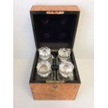 Fitted decanter box/tantalus with 4 decanters all with enamelled labels. The box of veneered