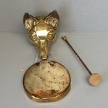 Brass foxhead holding a gong