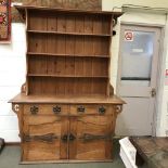 Oak 'Arts & Craft' Welsh dresser, 3 shelf plate rack over the base containing 2 cupboards with a
