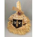 African hessian tourist mask decorated with animal fur, shells & grasses (selling for Prospect