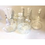 A number of decanters, glass bowls, vases etc