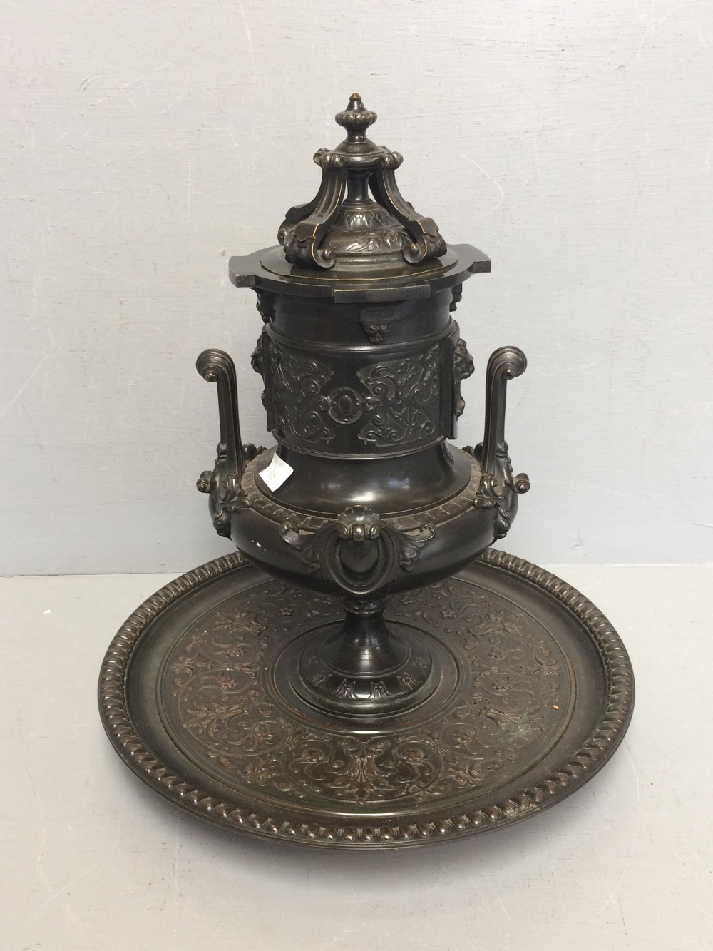 Ornate metal centre piece, possibly a tobacco jar on a circular base. 38 h cm 34 cm d