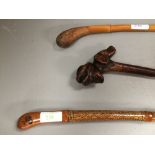 Blackthorn cattle stick with huntsman & foxhound carved handle, camel racing stick and another (3)