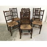 Harlequin set of 7 oak stick back, rush seat dining chairs