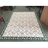 Portuguese needlepoint rug with floral motif on a cream ground with a green border 240 x 310 cm