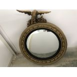 Circular convex Regency gilt mirror with eagle finial 102cm overall height