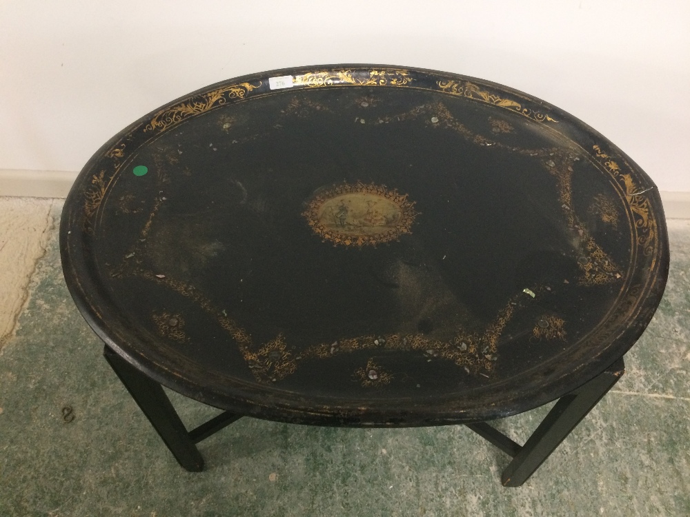 Oval toleware tray on a stand ( worn)