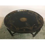 Oval toleware tray on a stand ( worn)