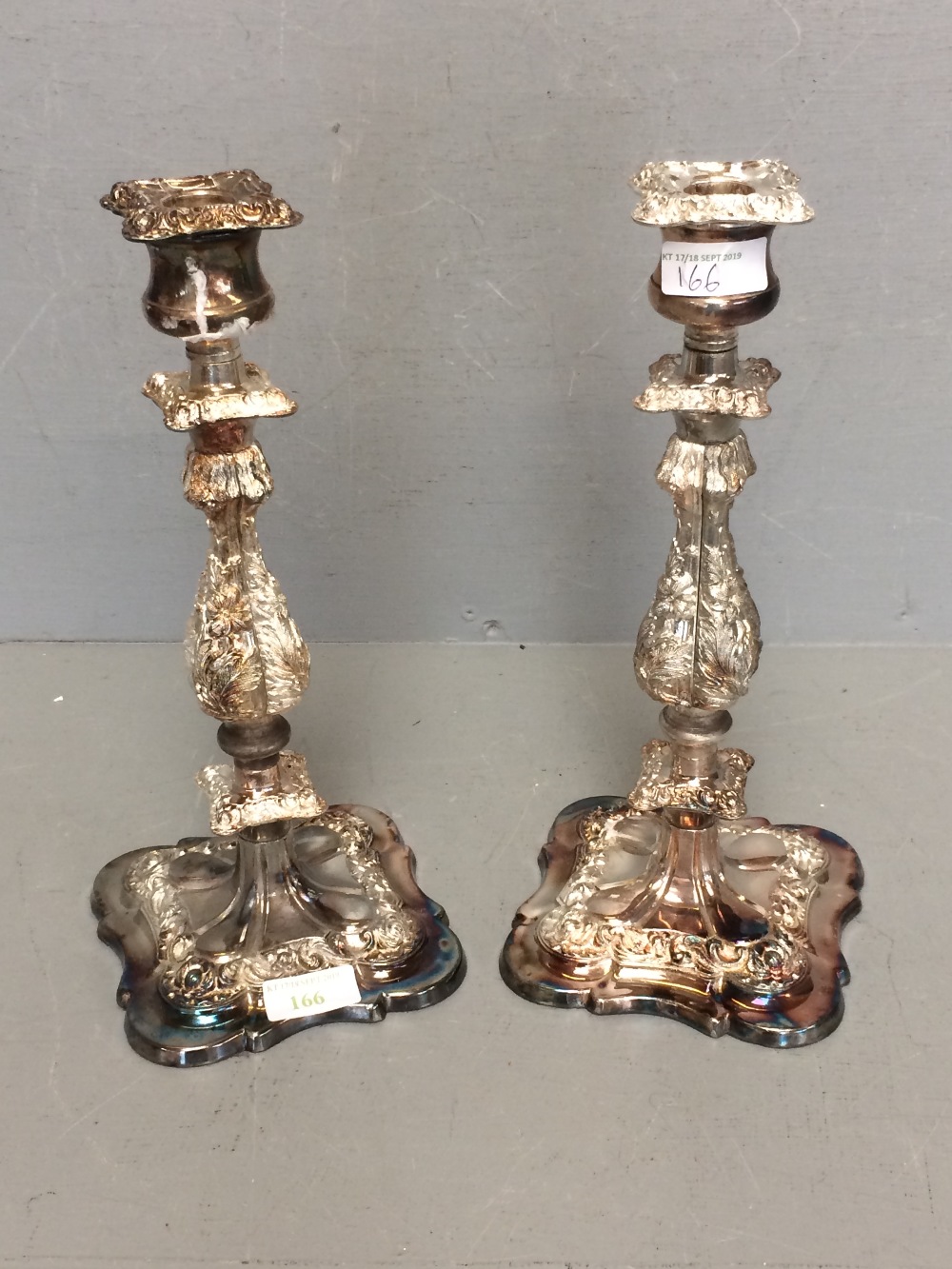 Pair of white metal candle sticks with floral decoration 30.5cm