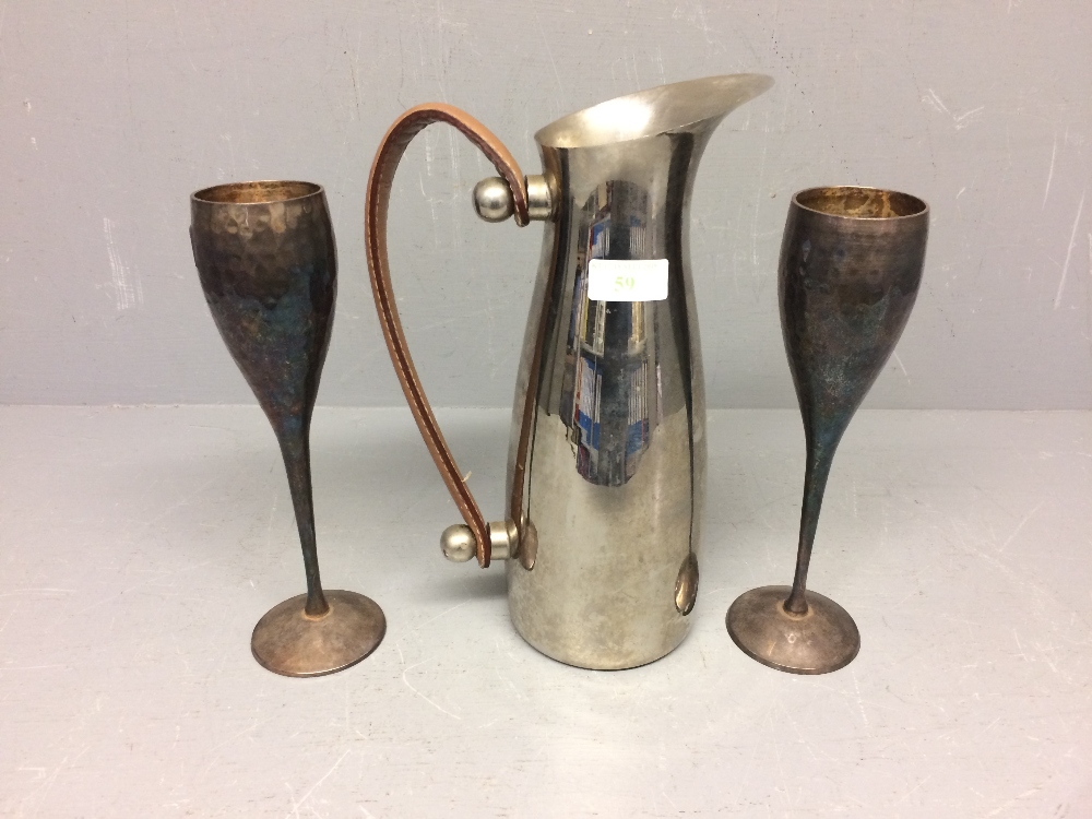 2 White metal champagne flutes, stainless steel water jug with leather handles