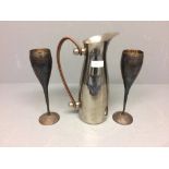2 White metal champagne flutes, stainless steel water jug with leather handles
