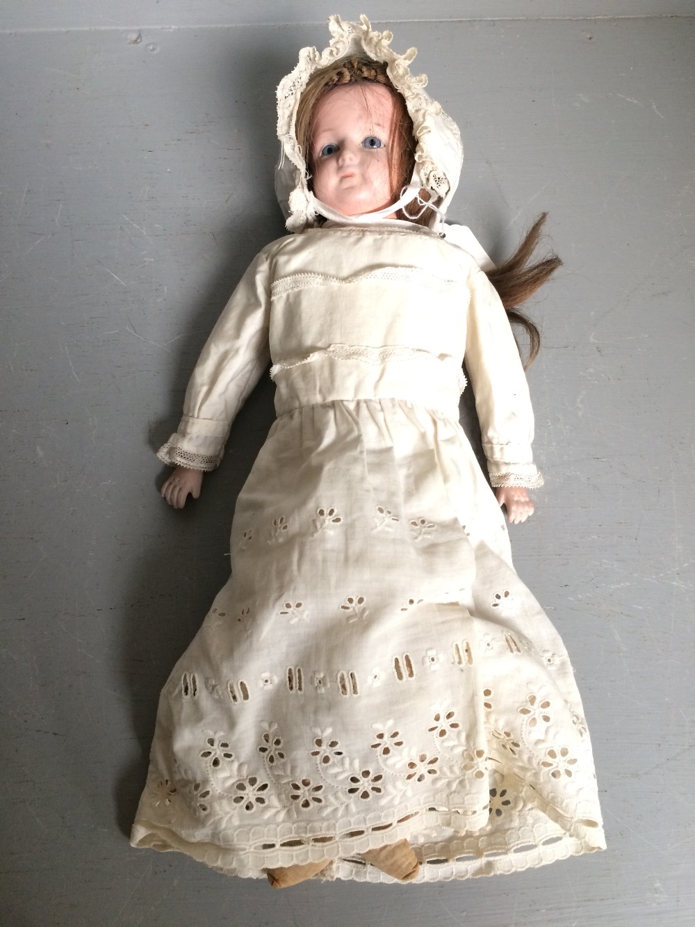 Unmarked porcelain bodied & headed doll with original clothes 39 cm