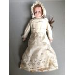Unmarked porcelain bodied & headed doll with original clothes 39 cm