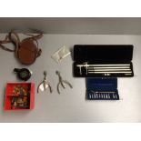 Box of Regimental buttons, badges etc, pair of spurs, prismatic military compass in leather case,