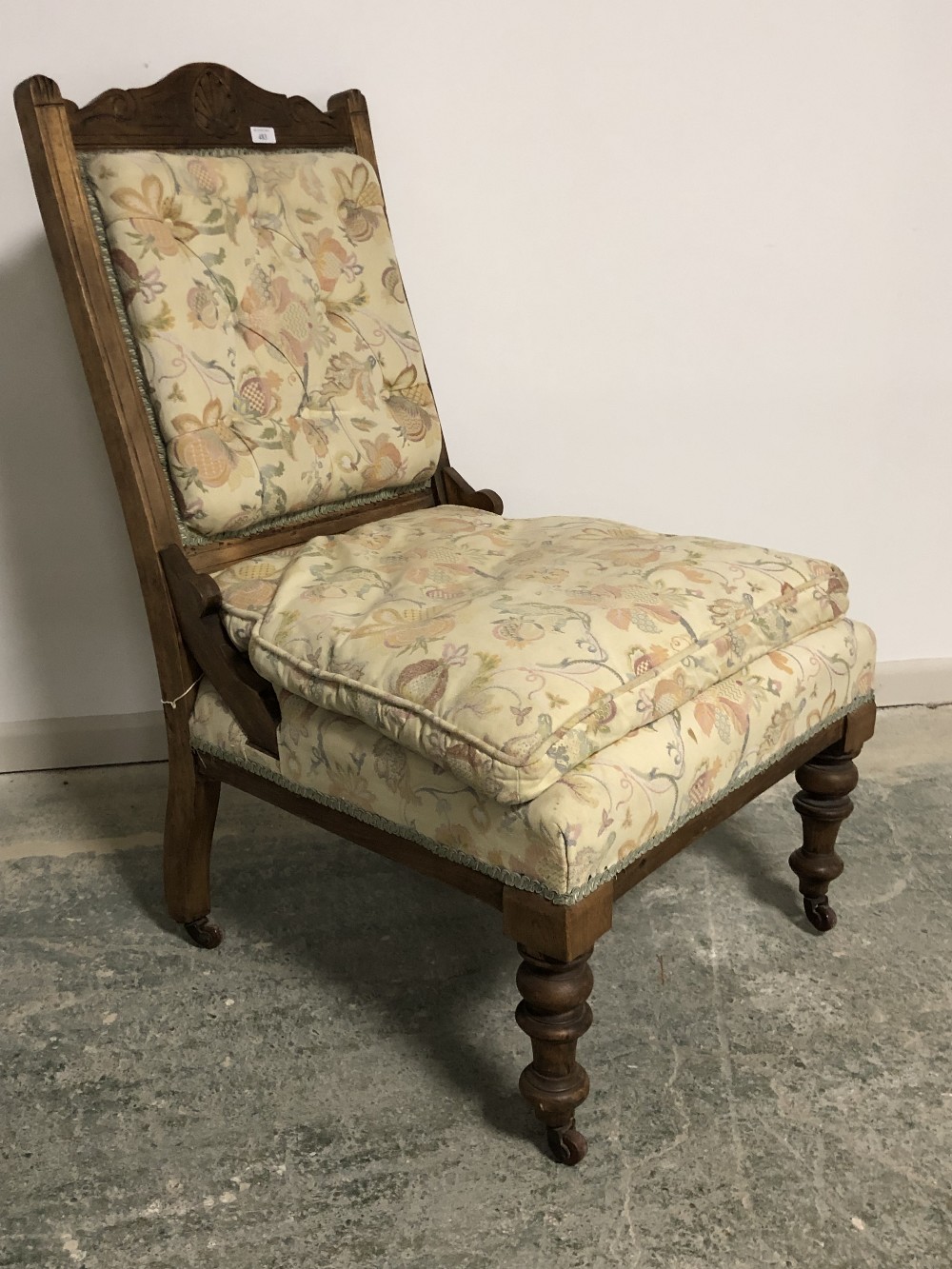 Late Victorian Beech framed fireside chair on turned legs to castors, upholstered in a beige & - Image 3 of 4