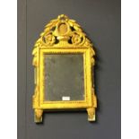 Regency gilt mirror with carved acanthus leaf finial 33 x 56 cm